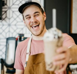 laughing employee while holding ice cream cup